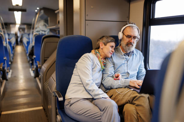 istock Mature couple using laptop while traveling by train 2090910473