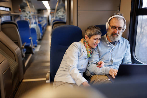 istock Mature couple using laptop while traveling by train 2090916167
