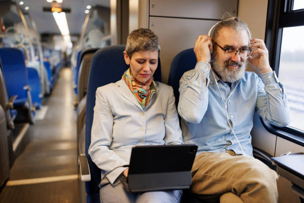 istock Mature business couple using laptop while traveling by train 2090923785