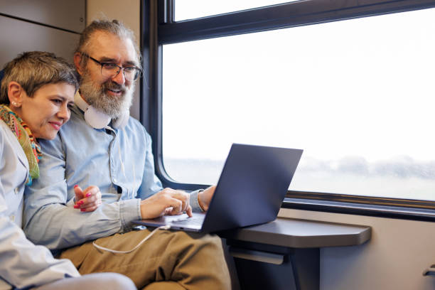 istock Mature business couple using laptop while traveling by train 2090926508