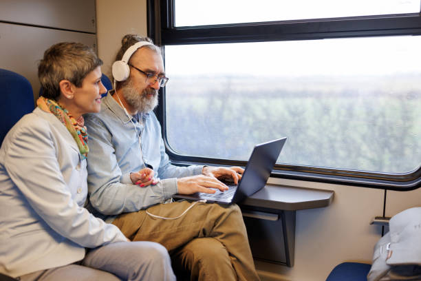 istock Mature business couple using laptop while traveling by train 2090927030