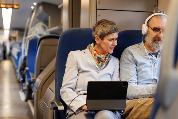 istock Mature business coworkers using technology while traveling by train 2090928599