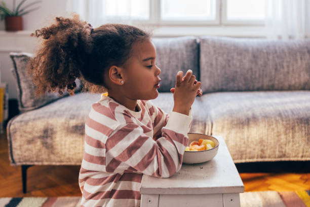 istock Young Girl Praying Before Eating Breakfast at Home 2090969123
