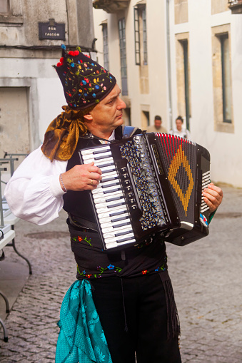 The musician playing the accordion on white background