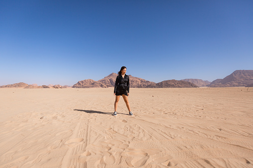 A young woman walking in Wadi rum desert