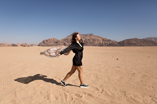 A young woman walking in Wadi rum desert