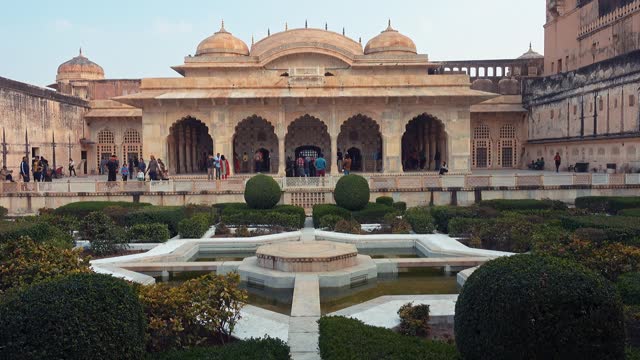 An interior landscaped courtyard and garden with Indian architectural elements, inside the Amer Fort in Jaipur