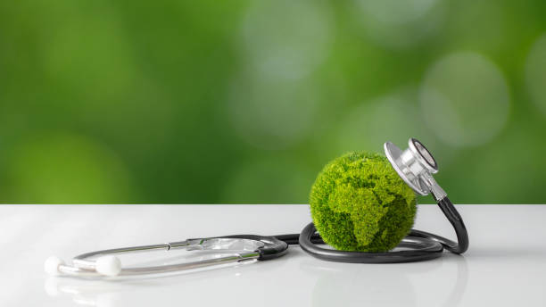 istock Green globe with a stethoscope wrapped around it. World Environment Day concept. Sustainable development goals. World Earth day. Ecology. environmental suitability. ESG. co2. Net zero. climate change. 2091028272
