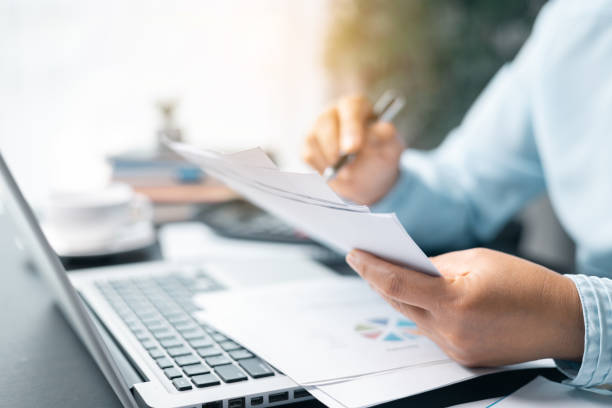 istock Business woman working on documents looking concentrated with briefcase on table. Businesswoman is deeply reviewing a financial report for a return on investment or investment risk analysis. 2091032964
