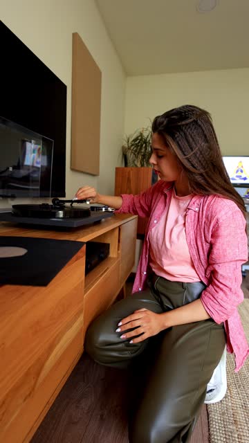 Woman Plays Records While Drinking Coffee