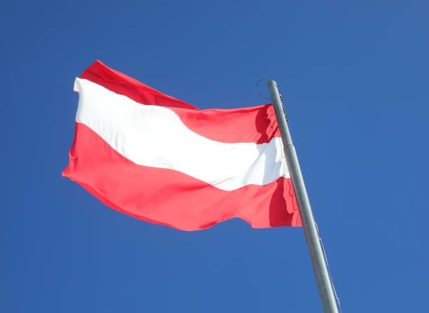 istock Austrian flag with red and white stripes against a sky background in Vienna  Austria 2091049645