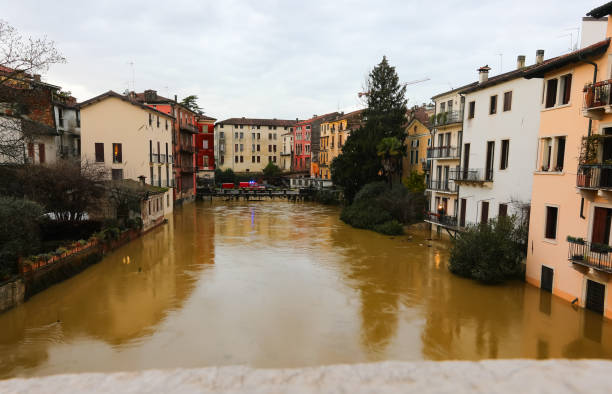 istock fire truck with sirens on the bridge during the river flooding while raining 2091060785