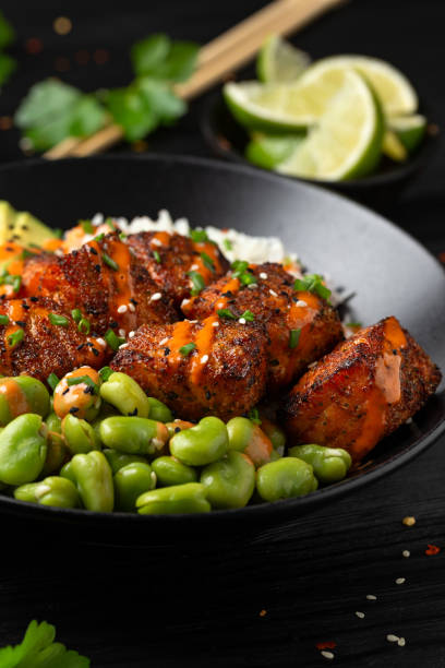 istock Firecracker salmon poke bowl with edamame, avocado carrot and rice 2091061843