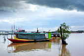 Riverside view with boats and bridge in Bangkok