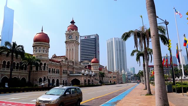 Sultan abdul samad building, a government building, one of Kuala Lumpur's most prominent historical landmarks, with traffic on the road during the morning hours.