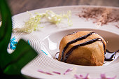 hot deep fried cold vanilla ice cream in bread with chocolate sauce in white plate on wood table asian cafe sweet dessert halal food restaurant menu