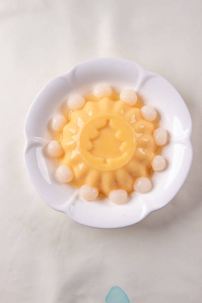 istock ice cold cute yellow mango fruit pudding big xmas tree mould jelly in plate with longan fruit decor on wood table asian cafe sweet kids dessert halal food restaurant menu 2091079945