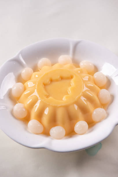 istock ice cold cute yellow mango fruit pudding big xmas tree mould jelly in plate with longan fruit decor on wood table asian cafe sweet kids dessert halal food restaurant menu 2091080460