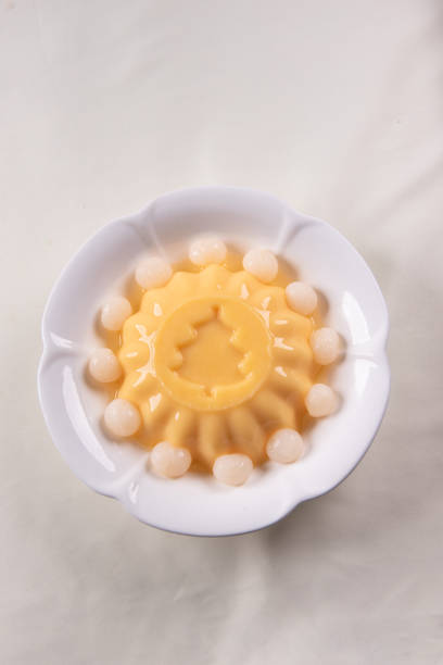 istock ice cold cute yellow mango fruit pudding big xmas tree mould jelly in plate with longan fruit decor on wood table asian cafe sweet kids dessert halal food restaurant menu 2091080467