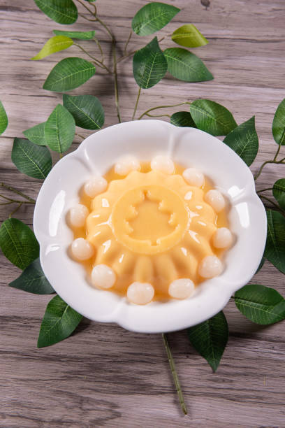istock ice cold cute yellow mango fruit pudding big xmas tree mould jelly in plate with longan fruit decor on wood table asian cafe sweet kids dessert halal food restaurant menu 2091081519
