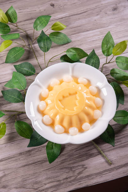 istock ice cold cute yellow mango fruit pudding big xmas tree mould jelly in plate with longan fruit decor on wood table asian cafe sweet kids dessert halal food restaurant menu 2091082558