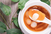 luxury traditional ice cold longan peach gum sea coconut sweet soup in white bowl on wood table asian cafe sweet dessert halal food restaurant menu