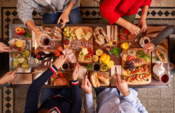 istock Faceless friends enjoying festive food at table 2091086942