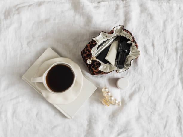 istock A cup of coffee, a notebook, a cosmetic bag on a light background, top view 2091090073