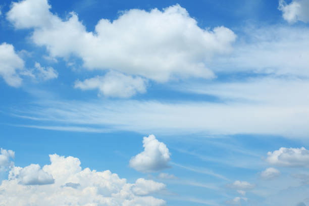 The blue sky and white clouds floated in the sky on a clear day.