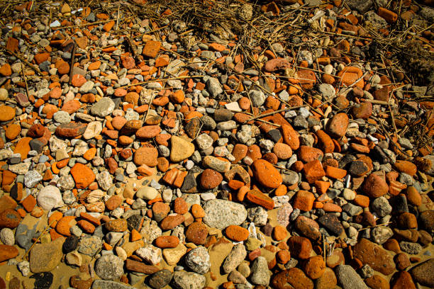 Pebbles, rocks and stones in the sand at the beach
