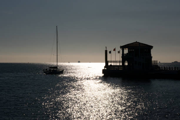 A boat sailing and passing to ferry dock.
