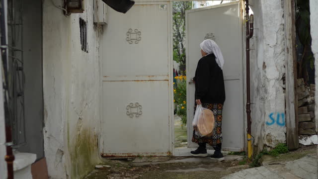 Woman taking pita bread home for iftar dinner, Turkey