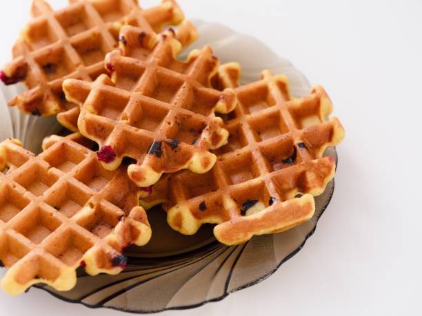 istock Four tasty homemade waffles on a plate on a white table. 2091243978