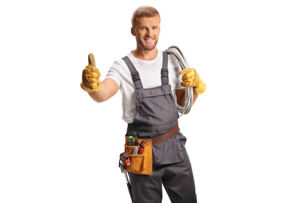 istock Electrician in a uniform carrying cables on his shoulder and gesturing thumbs up 2091271771