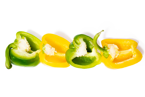 Multicolored Paprika on the white background. Cut out. Cross section of pepper with seeds.