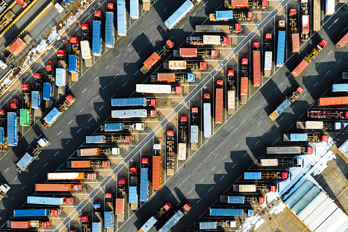 Aerial View, Rows of Trucks Driving in Harbor with Trailers