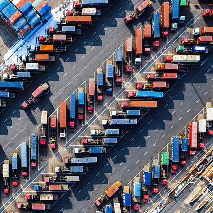 Aerial View, Rows of Trucks Driving in Harbor with Trailers