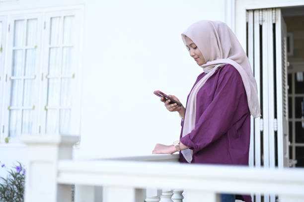 istock Young Muslim Woman Using Mobile Phone 2091318693