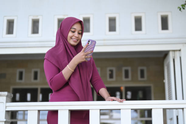 istock Young Muslim Woman Using Mobile Phone 2091332706