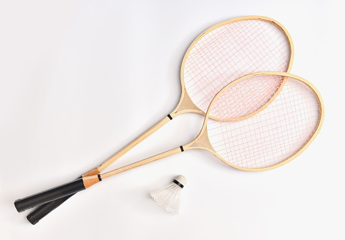 Sports equipment rackets and shuttlecock for badminton with copy space top view on a white background