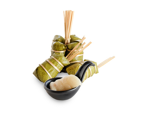 Khao Tom Mad, sweet glutinous coconut milk mixed, banana beans or taro paste inside wrapped with banana leaf and steamed, isolated on white background with clipping path, flay lay