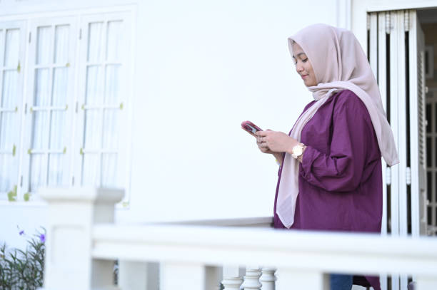 istock Young Muslim Woman Using Mobile Phone 2091343212