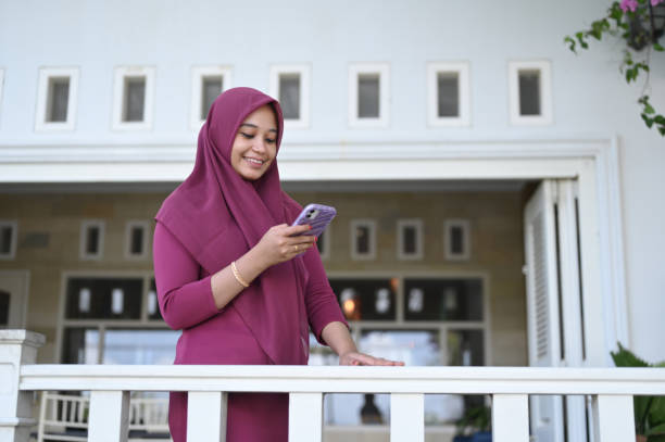 istock Young Muslim Woman Using Mobile Phone 2091347410