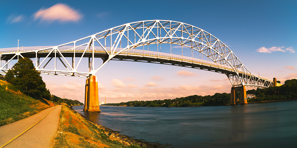 Sagamore Bridge the Landmark Architecture and Riverbank Footpath at Twilight along Cape Cod Canal on Cape Cod, Massachusetts, USA, Long Exposure photo