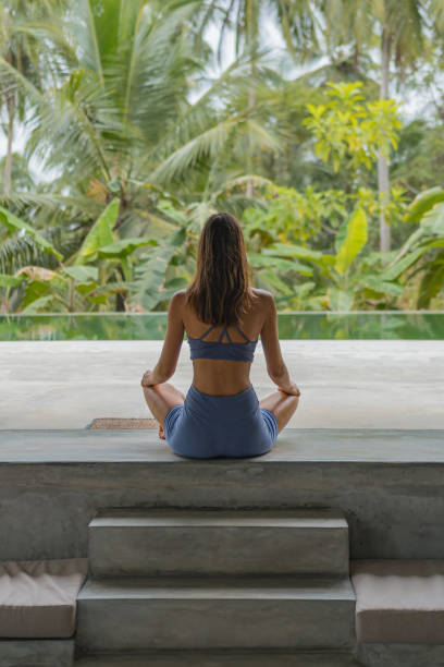 istock Young woman performs breathing exercises 2091356154