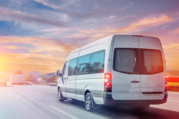 istock Passenger white minibus accelerating ride motion blur effect, in the morning at dawn. 2091356159