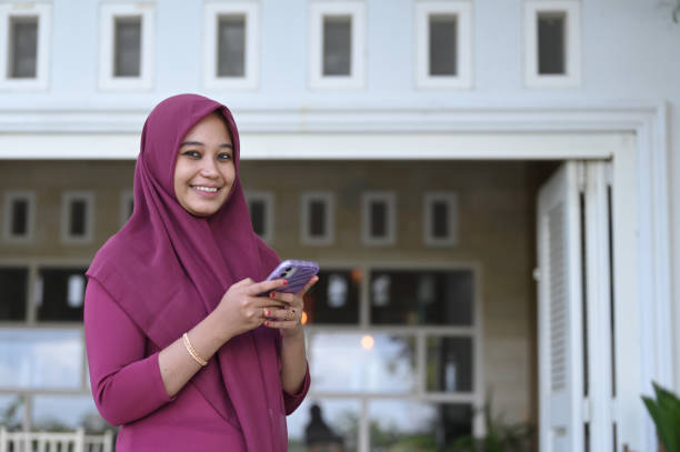 istock Young Muslim Woman Using Mobile Phone 2091357187
