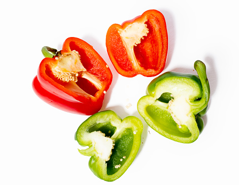 Multicolored Paprika on the white background. Cut out. Cross section of pepper with seeds.