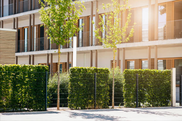 istock Modern Landscaping - Green Mesh Fence with Hedge Bushes 2091366510