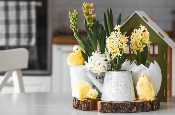 istock Happy Easter. Spring yellow hyacinth flowers in an egg-shaped vase, chicken chicks on a white table. In the background is a white Scandinavian-style kitchen. Easter decor in the house. 2091375962
